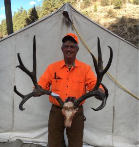 Guide DuWane Adams with a mule deer buck gross-scoring 213 that he glassed up for a client on Arizona’s Kaibab Plateau during a 2017 rifle hunt.