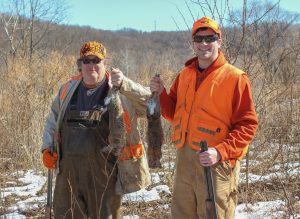 Teamwork can fill bags. Beagles tend to push rabbits in a circle before they dash into an open area where hunters are waiting. Two facing in different directions can better tackle the unpredictable direction rabbits will take when pushed from cover. Blaze orange keeps everyone safe.