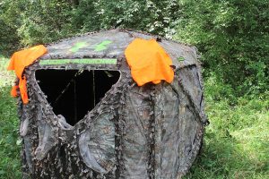 If your blind doesn’t come with blaze orange panels, something as simple as hanging hunter-orange vests from each corner will alert other hunters in the area to your location.