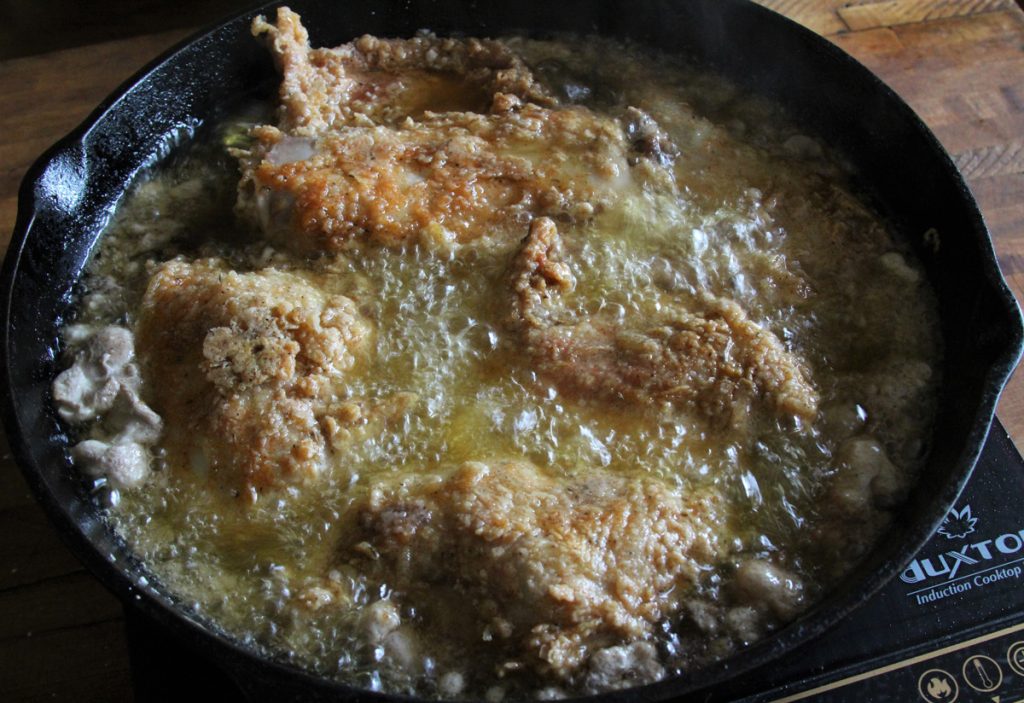 Fry the rabbit in a mixture of vegetable oil and lard, covering the pan for part of the cooking process to help the rabbit cook through.