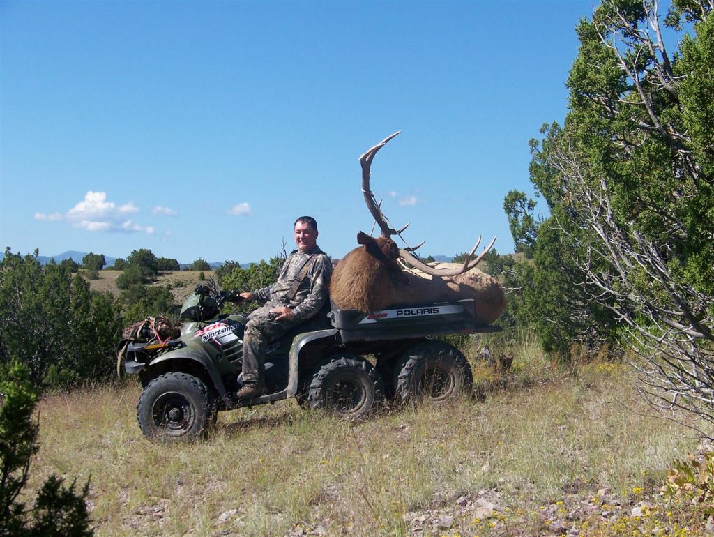 The general rifle season is a tough time to kill a bull, but it can be done. Just ask this smiling hunter!