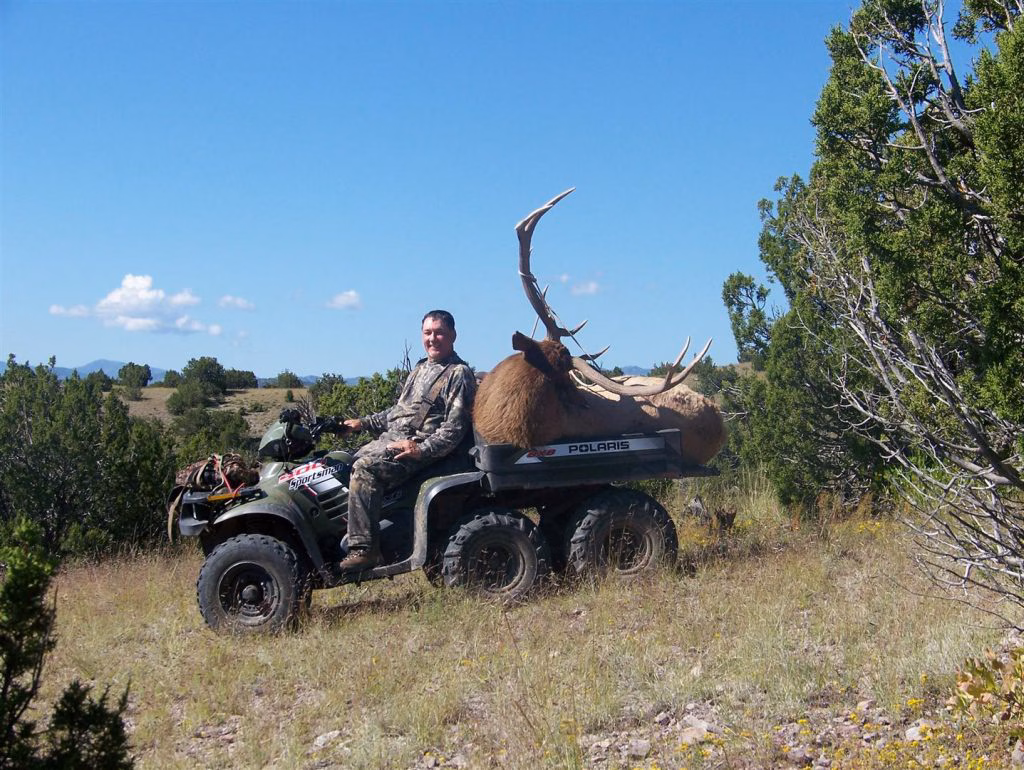The general rifle season is a tough time to kill a bull, but it can be done. Just ask this smiling hunter!